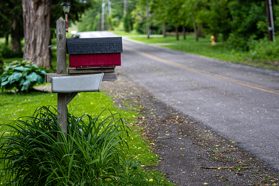 a traditional American mailbox on the side of a rural road