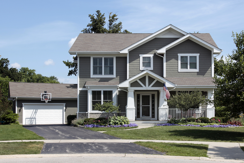 Suburban home with American Flag and basketball basket